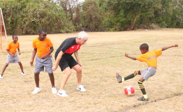 Ian Rush taking on this player during yesterday’s coaching clinic at the National Sports Council.