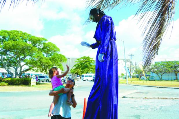 WELCOME TO BARBADOS! This little one had lots of fun interacting with this stilt-walker as the Barbados Tourism Product Authority (BTPA) hosted ‘Barbados Uh Come From’ marketplace for visitors.  The marketplace, which stretched from Trevor’s Way to the Pelican Craft Centre provided the opportunity for thousands of cruise visitors to sample a variety of locally made items, from food, beauty products, arts and craft.  (See Page 3)