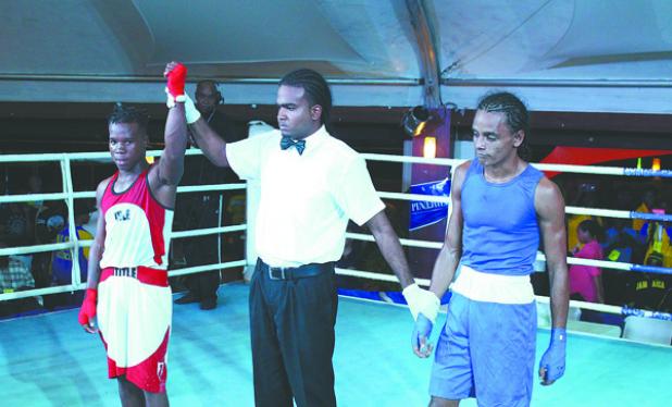 Barbados’ Jabali Breedy triumphs over his Guyanese opponent Kevin Allicock in the Men's Elite Caribbean Development Boxing Tournament at the Sea Rock Dome on Saturday. 