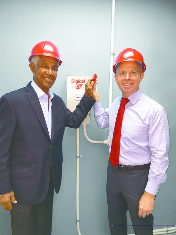 National Hero and Digicel Brand Ambassador, the Right Honourable Sir Garfield Sobers (left) and Chief Executive Officer of Digicel Barbados, Conor Looney switching on the Digicel LTE network.   
