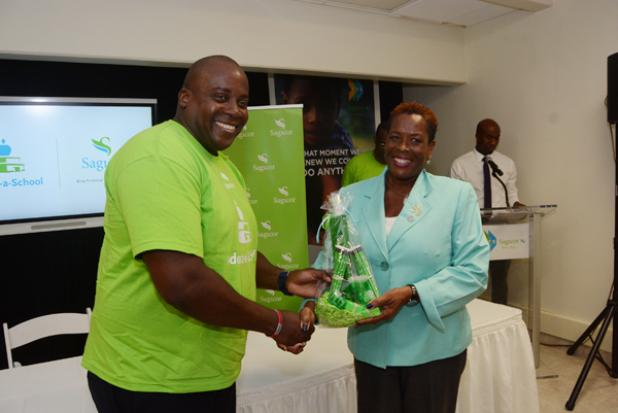 Principal of Hillaby/Turner’s Hall Primary Angela Edwards (right) receives a gift from Sagicor representative at the school, Wayne Alleyne. 
