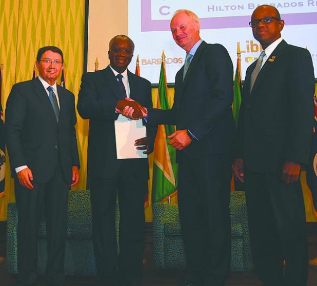 Prime Minister the Rt. Hon. Freundel Stuart was yesterday presented with the UNWTO/WTTC Open Letter by President and CEO of the World Travel and Tourism Council, David Scowsill (second from right), as UNWTO Secretary-General, Taleb Rifai (left) and Secretary General of the Caribbean Tourism Organisation, Hugh Riley (right) look on, at the Hilton Barbados Resort. 