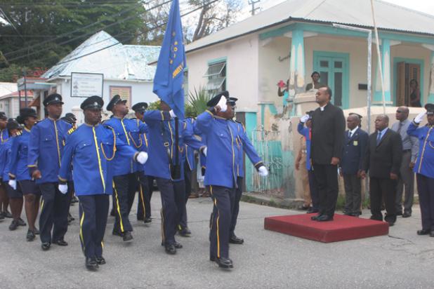 Security guards saluting Minister of State in the Office of the Prime Minister, Senator Patrick Todd and other officials on their march from Bay Street after the Service of Thanksgiving to Celebrate 40 years of the Government Security Guards Service yesterday at the St. Paul’s Anglican Church. 