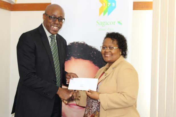 Sophia Howard (right) from Sagicor presenting Jerry Blenman, interim CEO of the NSC, with a cheque.      
