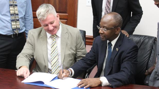 FROM LEFT: David McGregor, Vice President, Asset Management – Emera Caribbean, and Stephen Lashley, Minister of Culture, Sports and Youth signing the Memorandum of Understanding.