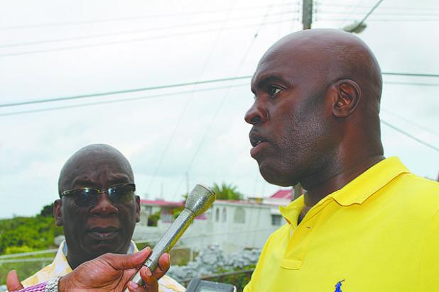 Minister of Transport and Works, Michael Lashley (right) making a point to the media while on a tour of flood damage yesterday. Looking on is Minister of Education, Science, Technology and Innovation, Ronald Jones.    