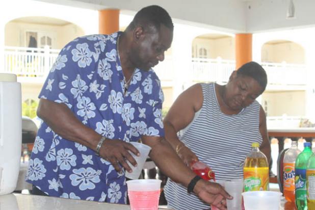 Member of Parliament for the St. Michael Central constituency, Steven Blackett, helping to share the drinks for the youngsters.