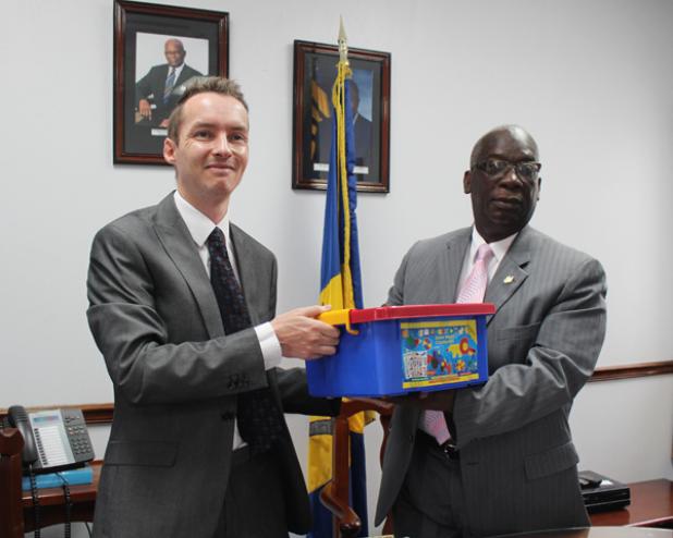 Minister of Education, Science, Technology and Innovation, Ronald Jones (right), accepts just one of the 144 Morphun Junior Model Construction kits to benefit children in the nursery and primary schools, from Martin Robinson, Head of Political, Press and Public Affairs at the British High Commission in Barbados.