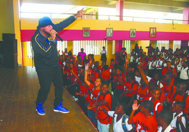 Entertainer Peter Ram sings the ‘Stop The Bullying’ theme song with Grantley Adams students during the ‘Celebrate Kindness: No Name-calling Day’ initiative.  