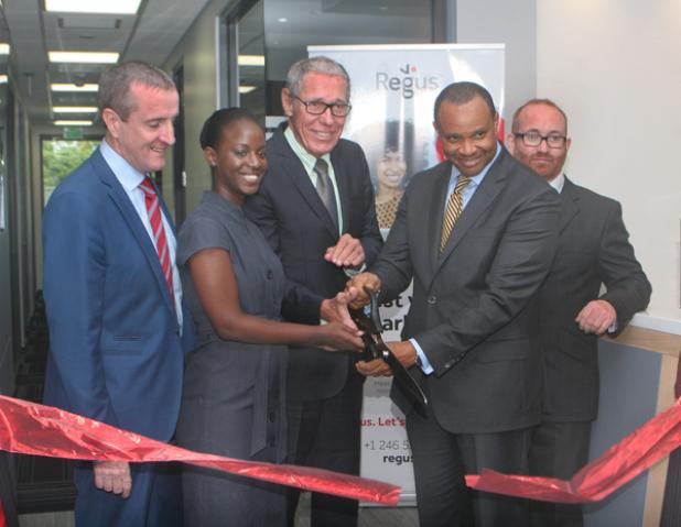 Finance and Economic Affairs Minister, Christopher Sinckler (second from right) with the help of (second from left) Customer Service Representative, Cheria Kippins and Chairman of Williams Industries Incorporated, Ralph ‘Bizzy’ Williams (centre), cutting the ribbon to officially open the Regus Business Centre. Looking on is Managing Director of Regus, Mark Linehan  (left) and General Manager, Stuart May (right).  