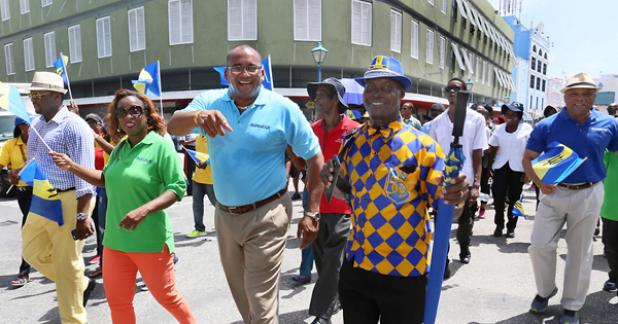 CEO of the Barbados Tourism Product Authority (BTPA), Dr. Kerry Hall (second left) and Acting Prime Minister and Minister of Tourism and International Transport, Richard Sealy (second right) making their way down Broad Street during the Tourism Workers’ Parade.