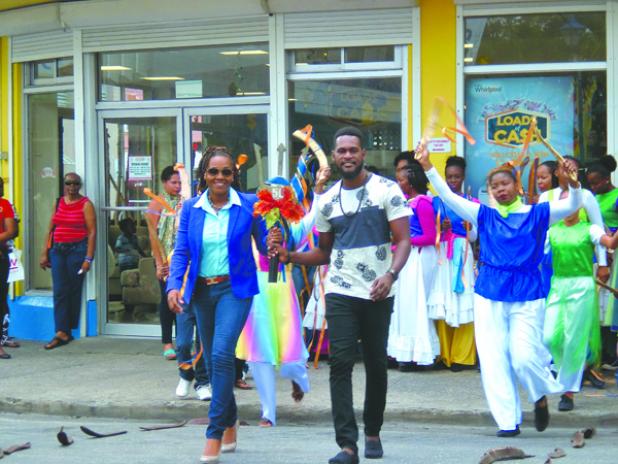 The Broken Trident being carried by local Gospel Artistes John Yarde and Neesha Woods to the official launch of Gospelfest 2016 at Jubliee Gardens, in the City yesterday.
