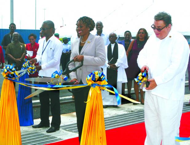 From left to right: Chief Executive Officer of the BPI, David Jean-Marie; Parliamentary Secretary in the Ministry of Tourism and International Transport, Senator Irene Sandiford-Garner; and Chairman of BPI, David Harding, cutting the ribbons officially commissioning Berth 5 at the Bridgetown Port yesterday.