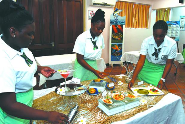 Three of the four-member team from the St. Winifred’s School setting up their dishes for the judging. 