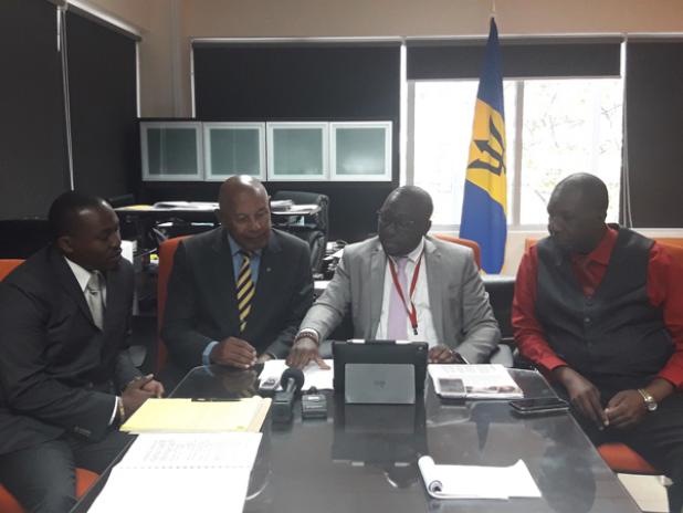 Minister of Small Business, Entrepreneurship and Commerce, the Hon. Dwight Sutherland in discussion with Member of the Co-operative Societies Appeals Tribunal,  Davidson Ishmael (left); Chairman, Anthony Reece; and Deputy Chairman, Hally Haynes.