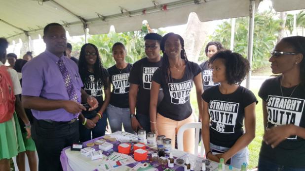 Minister of Industry, International Business, Commerce and Small Business Development, Donville Inniss engages Barbados Community College students at their booth in the car park of the Baobab Tower, as part of activities to mark World Intellectual Property Day.