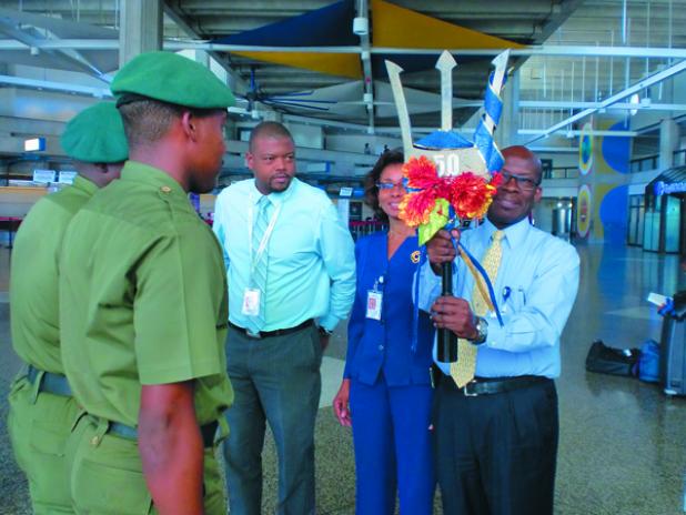 Acting Chief Executive Officer (CEO) of GAIA, Joseph Johnson, admiring the commemorative Broken Trident on receiving it from Officers of the Barbados Defence Force.