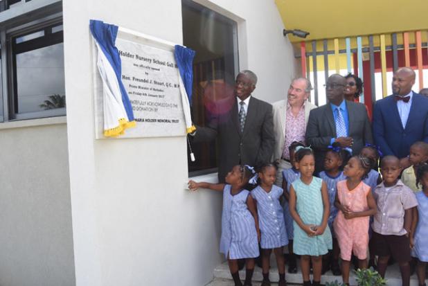 (from left) Prime Minister, the Rt. Hon. Freundel Stuart, unveils the plaque, officially opening the school. Looking on are (second from left) Chairman and Co-founder of the Maria Holder Memorial Trust, Christopher Holder, Minister of Education, Ronald Jones and Minister of Education of Antigua and Barbuda, Michael Browne.