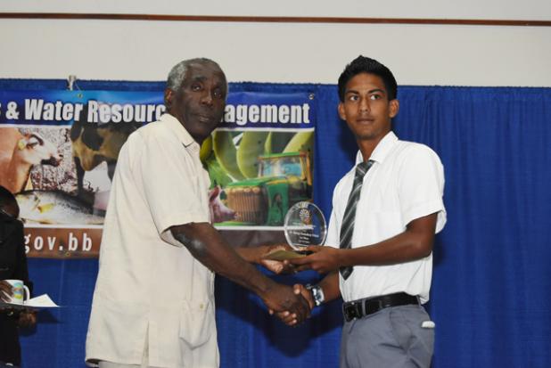 Jelani Hunte, from the Lodge School, the Winning Competitor of the Grow Well! School Gardening Competition.Jehru Latchman of St. George Secondary School received the award for his team, which captured first place in the Open-Field Gardening (Secondary) Category, in the Grow Well! School Gardening Competition, from Permanent Secretary in the Ministry Of Agriculture, Esworth Reid.