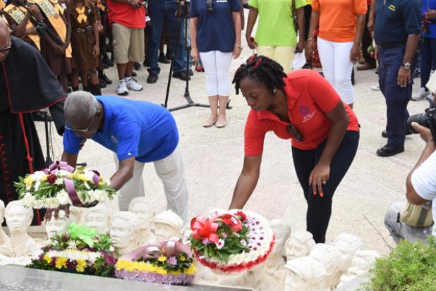 General Secretary of the Barbados Workers Union, Toni Moore (right), lays a wreath at the statue of National Hero, the Right Excellent Sir Frank Walcott, alongside former BWU General Secretary Senator Sir Roy Trotman.