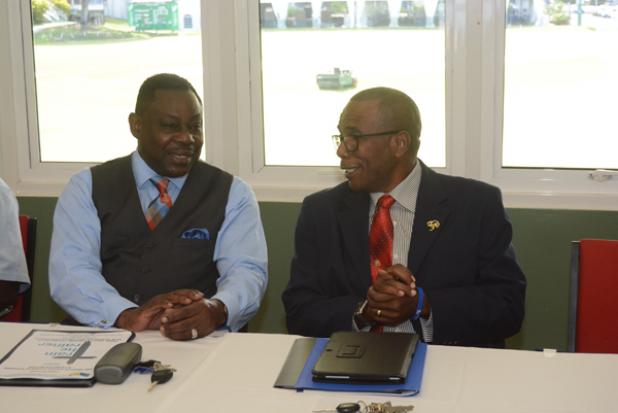 Minister of Social Care, Constituency Empowerment & Community Development, the Hon. Steven Blackett, speaking with the Rev. Clayton Springer of the Wesleyan Holiness Church of Barbados.