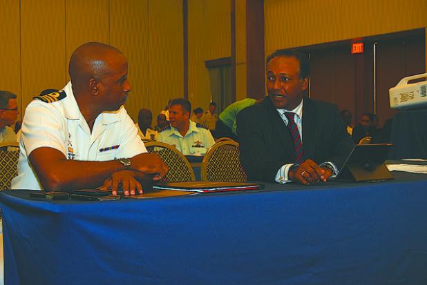 Deputy Chief of Staff of the Barbados Defence Force, Commander Errington Shurland (left) engaging Director of Public Prosecutions, Charles Leacock (right), in conversation.  