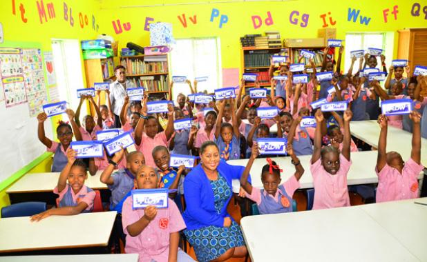 Flow’s vice president of technology, Nicôle Layne (centre), celebrates Safer Internet Day with students of Welches Primary, the company’s adopted school.