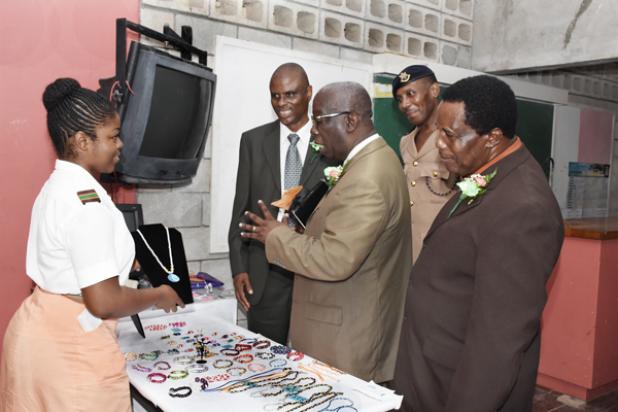 (left) Alisha Cumberbatch showing the Principal of Frederick Smith Secondary School, Jefferson Phillips; Minister of Education, Science, Technology and Innovation, Ronald Jones; Major Greene and the Deputy Principal, Clyde Collymore, her art pieces after the speech day event recently.