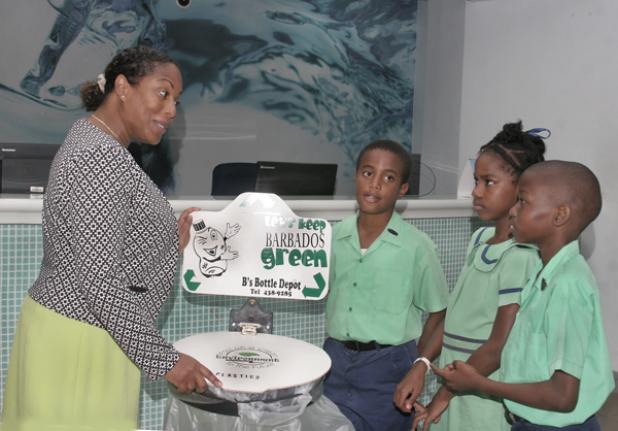 Senior Manager, Administration and Operations and Head of the Health and Safety and Going Green Committees at the Republic Bank, Michelle Pounder (left); chatting with Prefect, James Pounder; Head Girl, Charian Alexander; and Head Boy, Shaunisico Cyrus- Christian; all of the Good Shepherd Primary School – which the Republic Bank has adopted – at the launch of their Going Green Campaign 2017, on Wednesday evening at their Broad Street location.