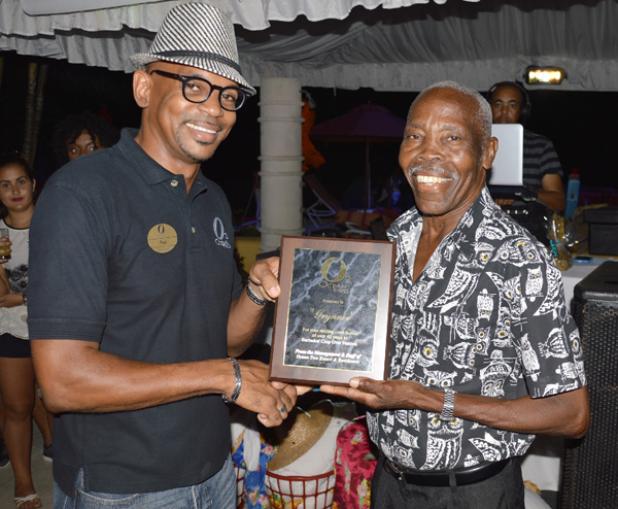 Mighty Grynner (right) was presented with a plaque by Paul Collymore, Operations Manager of Ocean Two Resort, where he was formally recognised for his contribution to entertainment in Barbados and the Diaspora.