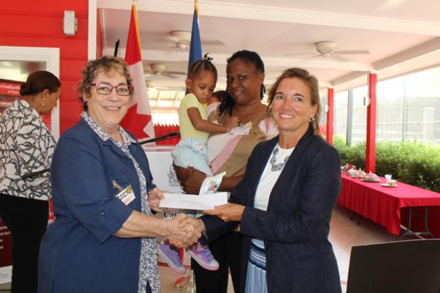 High Commissioner of Canada to Barbados and the Eastern Caribbean, Her Excellency Marie Legault (right), distributed the first set of funds to the Burnscar Garment and Orthotic Fund for Children, represented by Hilary Bethel (left). Bethel was accompanied by Sonia Brathwaite and her two year old daughter Sunjai Brathwaite, who is benefiting from wearing a burnscar garment.