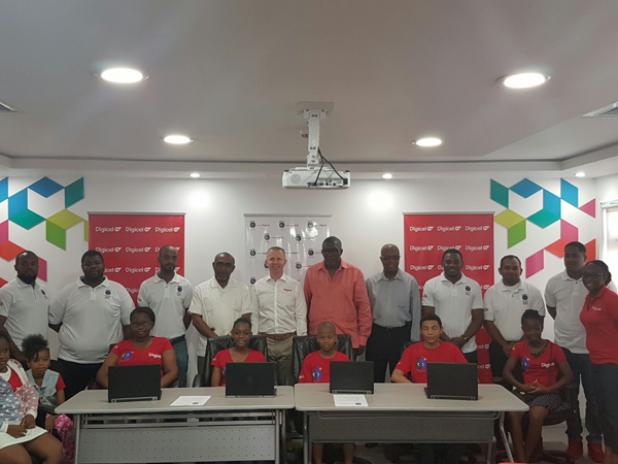 From left: Minister in the Prime Minister’s Office with responsibility for Energy, Immigration, Telecommunications and Invest Barbados, Senator Darcy Boyce; Chief Executive Officer of Digicel Barbados, Conor Looney; and Parliamentary Secretary in the Ministry of Education, Senator Harry Husbands, as they attended the launch surrounded by some of the students that will participate in CoderDojo.