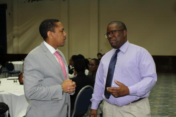 (left) Chief Executive Officer of the Financial Services Commission (FSC), Randy Graham, in conversation with President of the Institute of Internal Auditors Barbados Chapter, Eric Small, prior to the start of the conference.