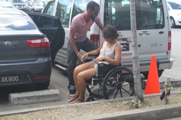 Radio Personalities, Patrick ‘Salt’ Bellamy and Caroline ‘CiCi’ Reid  demonstrating the difficulty persons with disabilities would facing while  manoeuvring in non-designated parking spaces.