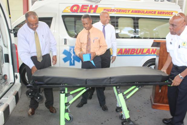 Health Minster, John Boyce taking a close look at one of the stretchers which will be inside the two new ambulances.