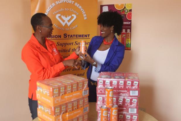 President of Cancer Support Services, Kathy-Ann Kelly-Springer, accepting the donation to that organisation from Cynthia Dawson, Brand Manager, Sparkling Ice.