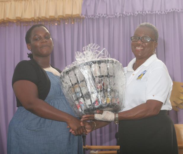 Project Chair of the St. Michael Parish Independence Committee, Wilma Trotman, making a presentation to Tamara Harris.