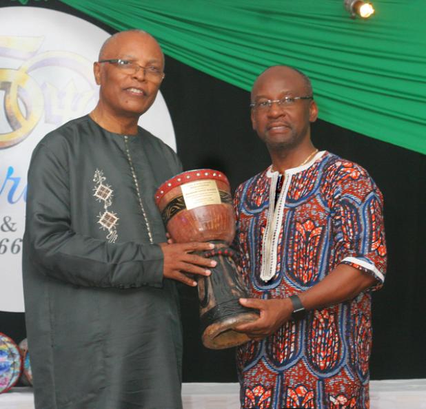 Honourable and Right Reverend Monsignor Vincent Blackett accepting his Religious/Spiritual Award from Minister of Culture, Sports and Youth, Stephen Lashley.