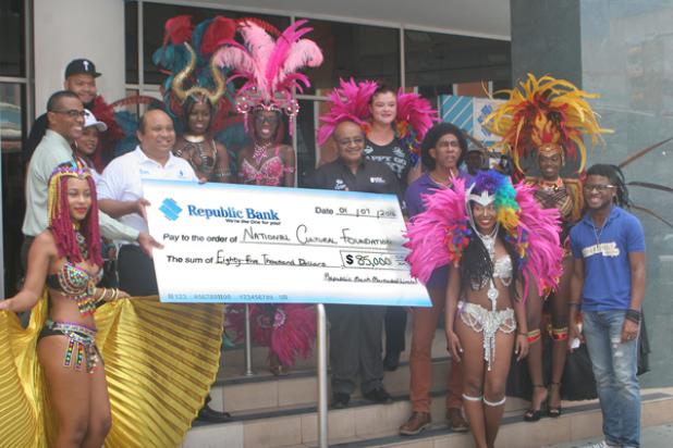 Representatives of the National Cultural Foundation collect the cheque to assist with Grand Kadooment.