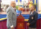 The Rt. Hon. Sir Lloyd Erskine Sandiford, former Prime Minister of Barbados and Old Scholar of the Coleridge and Parry School, and Head girl, Kiara Goodridge admiring the Commemorative Broken Trident, on its arrival to the Ashton Hall, St Peter school, yesterday.