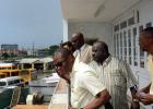 FROM RIGHT: Minister of Housing, Lands and Rural Development, Denis Kellman; Interim Chairman of the Association of Public Transport Operators (APTO), Morris Lee; and Minister of Transport and Works, Michael Lashley along with others who toured the new terminal building yesterday, looking down to where the PSVs operate.  