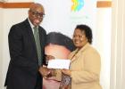 Sophia Howard (right) from Sagicor presenting Jerry Blenman, interim CEO of the NSC, with a cheque.      
