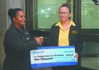 Operations Manager with the Barbados Council for the Disabled, Roseanna Tudor (right) accepting a cheque from Director of Engineering at GAIA, Karen Walkes. She also accepted the cheque on behalf of The National United Society for the Blind. 