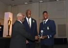 Shamar Springer (right) being congratulated by Governor General Sir Elliott Belgrave (left) after winning the President’s Award during the Barbados Cricket Association’s Awards Ceremony last Saturday evening at the Lloyd Erskine Sandiford Centre. Looking on is BCA President, Joel Garner.  