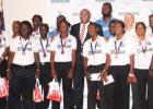 Government and Digicel officials pose with members of the West Indies Women’s and Men’s teams.   