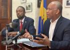 (Left) Minister of Labour and Social Partnership Relations, Colin Jordan listening as Attorney General of Barbados, Dale Marshall urged charities to reply.