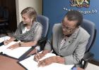 Canadian High Commissioner to Barbados, Marie Legault and Minister of Foreign Affairs and Foreign Trade, Senator Maxine McClean, sign off on the new air services agreement.