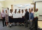 (At centre) Students and teachers of some of the schools participating in the programme pose with the cheque, along with (at left) BEF Chairman, Chris Decaires; and CEO, Celeste Foster; and (at right) Chairman of the Massy Foundation, Everton Browne; Consultant, Dr. Richard Graham and the Agriculture Ministry’s Youth Agri-preneurship Incubator Programme Manager, Kareem Payne.