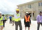 Attorney General, Adriel Brathwaite, shares a word with Registrar of the Supreme Court, Barbara Cooke-Alleyne, during a tour of the new police station (under construction) at Cane Garden St. Thomas yesterday.