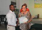 Jonathan Walcott, Manager/ Director of Jajaba Landscaping Services, accepting his prize from Second Vice-President of the Barbados Horticultural Society, Dr. Frances Chandler.